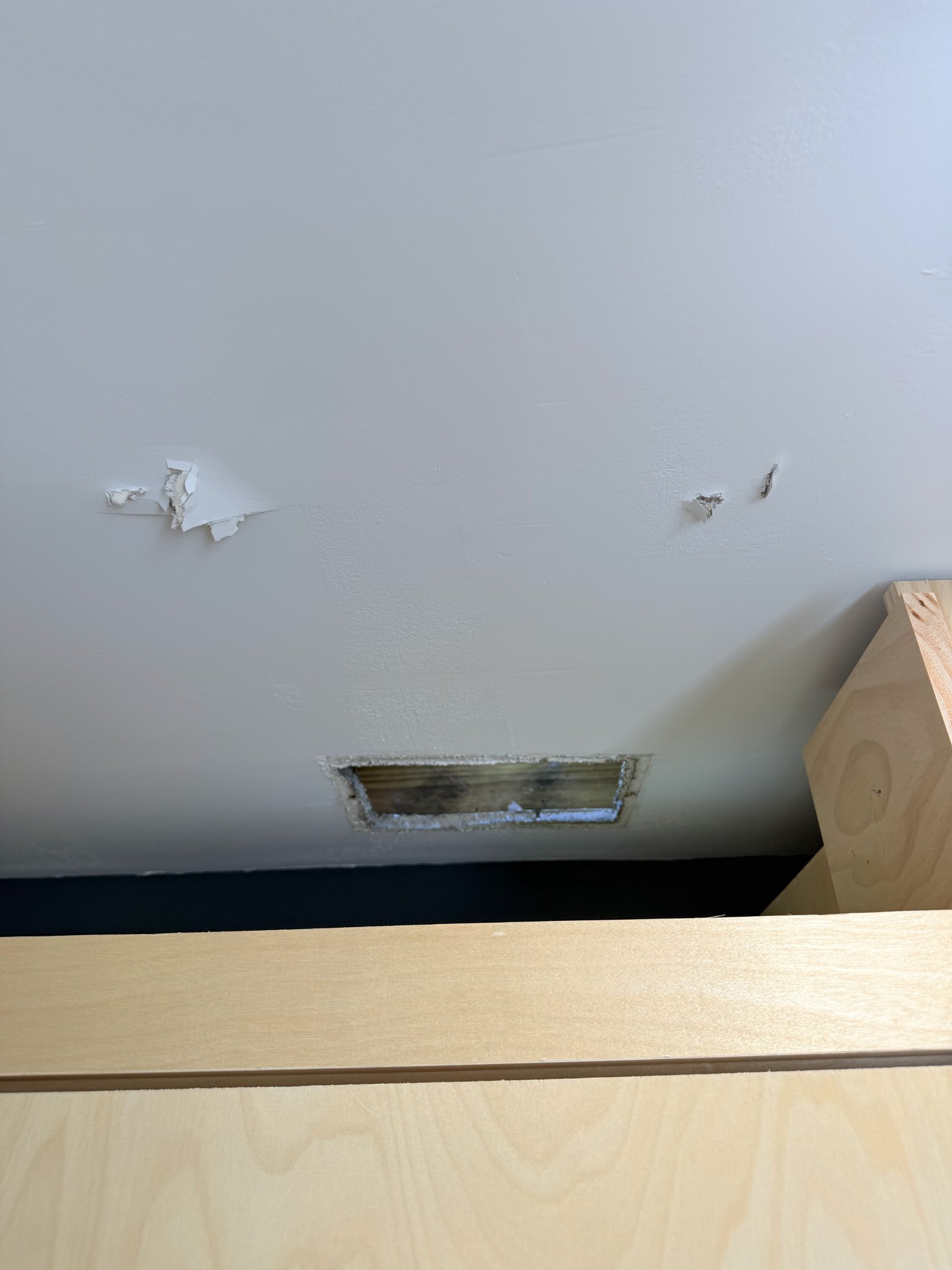 Before: damaged ceiling drywall repaired