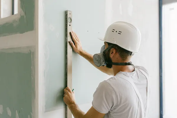 Contractor completing a drywall installation